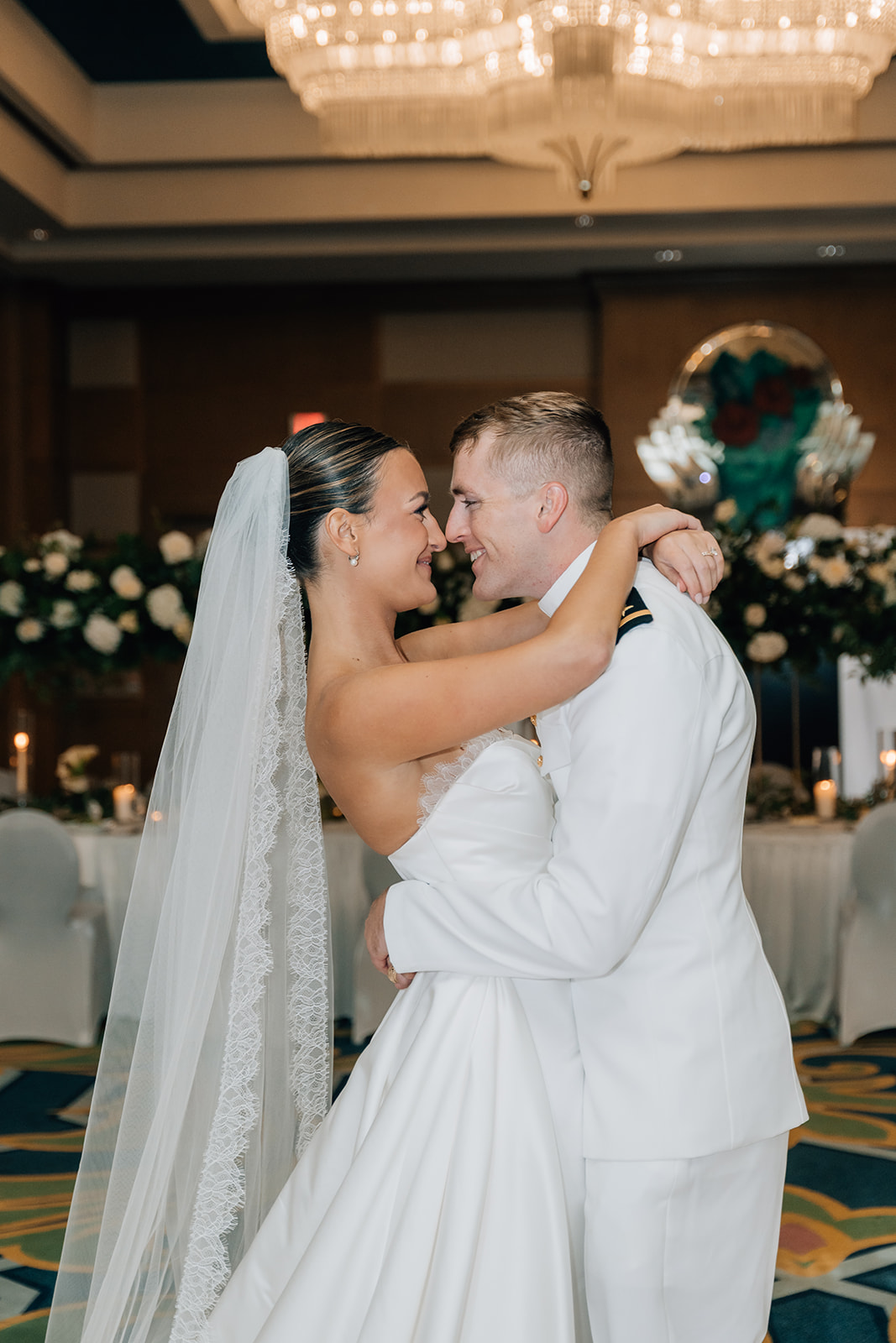 Bride and Groom hug and touch noses at Moody Gardens hotel in Galveston