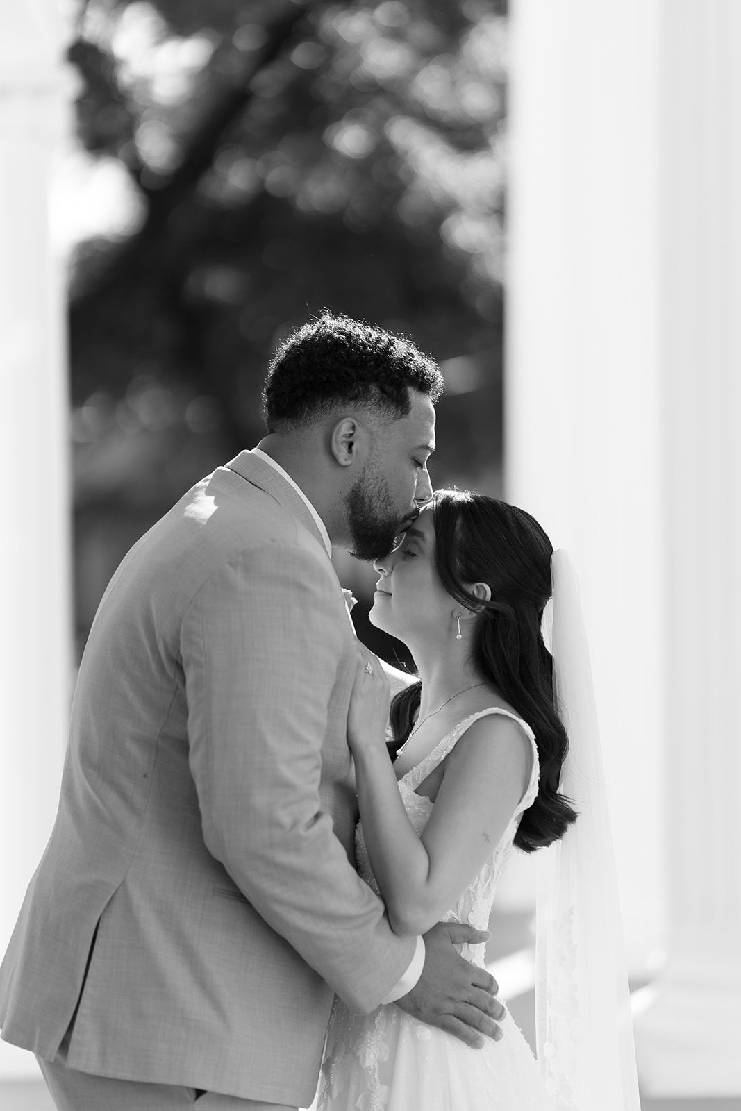 Groom Kisses Bride's forehead at Woodbine Mansion wedding in Round Rock, Texas