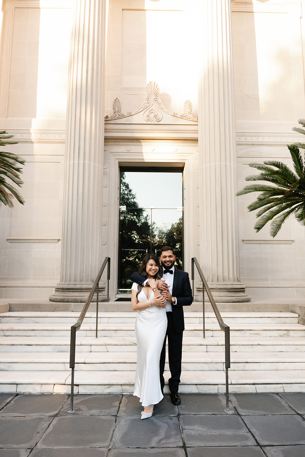 Engaged couple posing on the steps of The Museum of Fine Art, Houston during an outdoor engagement session by Houston wedding photographer Katia G