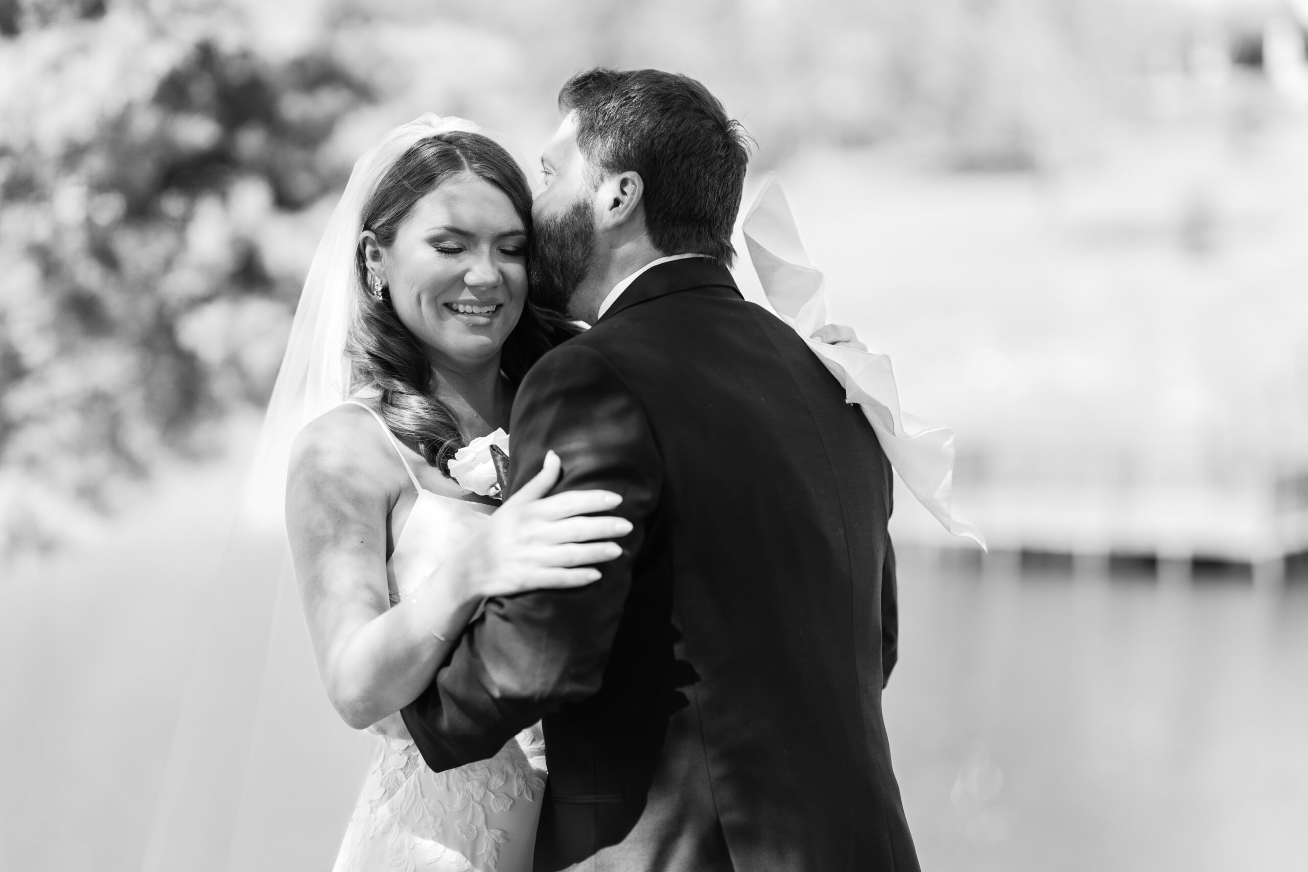 Timeless black and white wedding portrait of a bride and groom during their first look at RoseBridge venue in Smithville, TX, captured by a Houston wedding photographer.